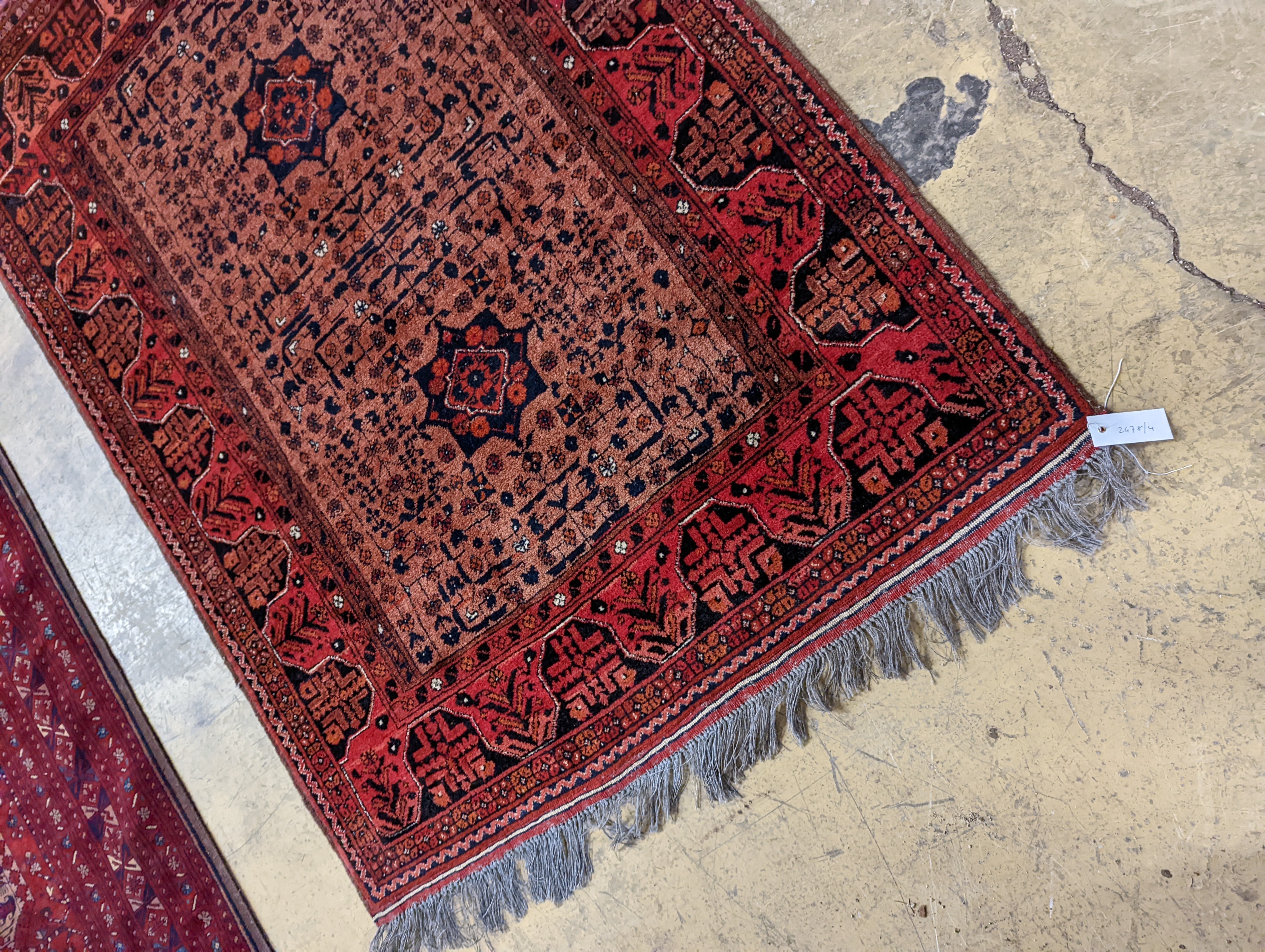 A Belouch red ground rug, 148 x 106cm